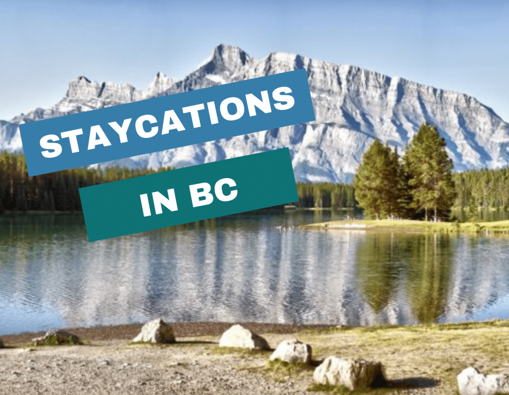 Snow-capped mountains reflected in a lake with pine trees on shore; bold text reads "STAYCATIONS IN BC"—your perfect inspiration for a relaxing staycation in BC.