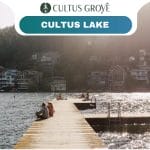 A wooden dock extends into Cultus Grove’s shimmering lake, with people relaxing on it; houses and trees line the sunny opposite shore. Text reads "Cultus Grove" and "Cultus Lake.