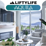 Modern living room with a wall-mounted TV, fireplace, large windows, gray sofa, indoor plant, and mountain view—an inviting retreat at Cultus Grove—under a banner that reads "LiftyLife Aquila.